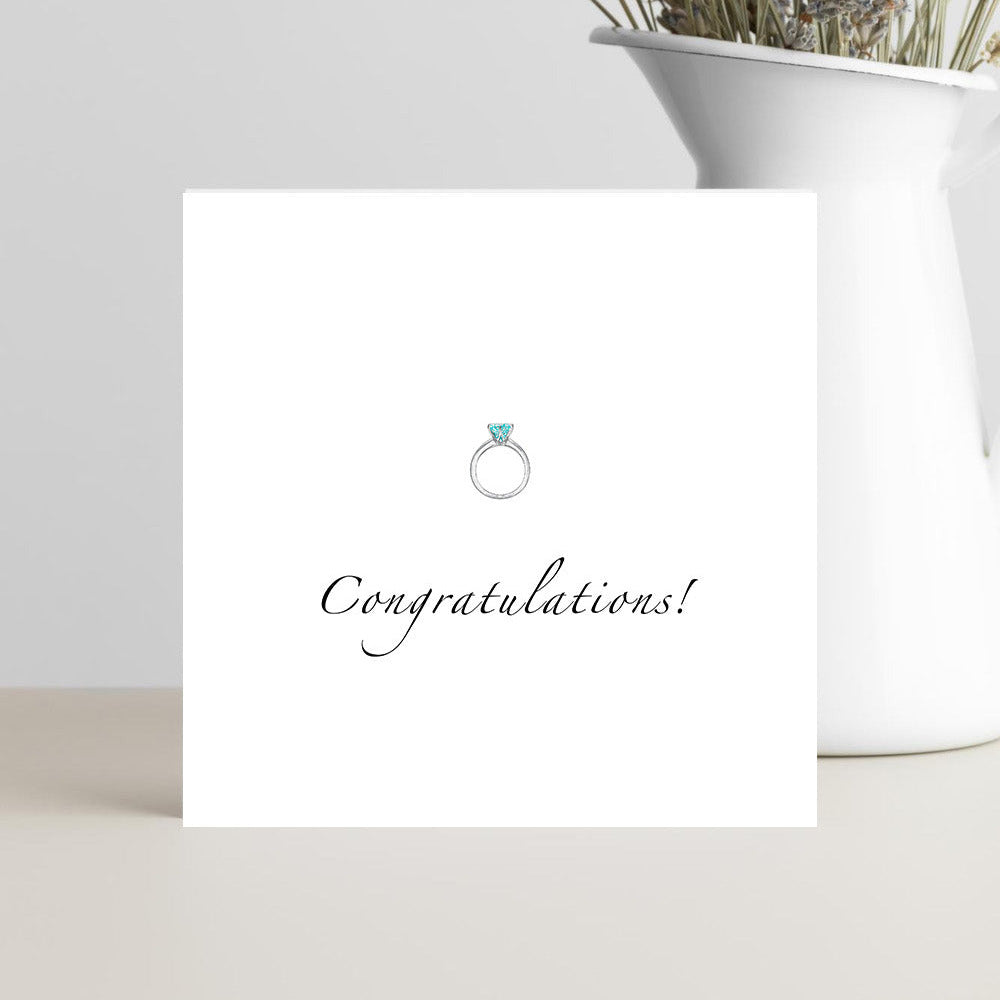 Minimalist engagement card with congratulations text and ring illustration