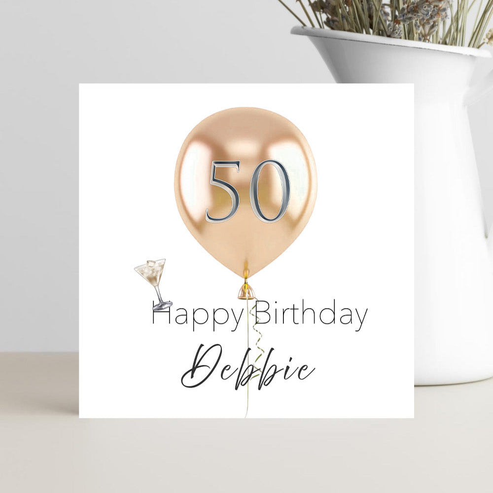 Milestone 50th birthday greeting card featuring a charming champagne coloured balloon and personalised name.