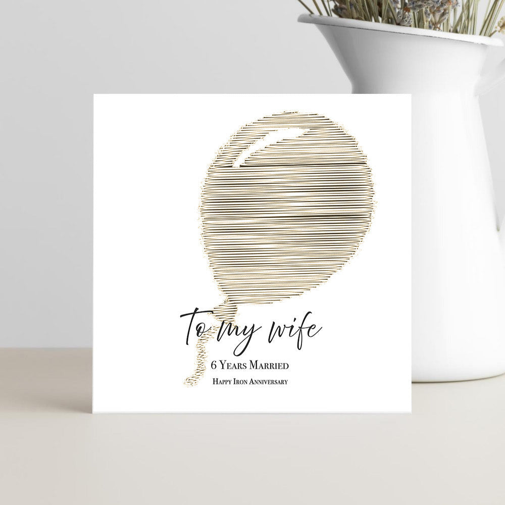 Greeting card with abstract design and text on a white surface.