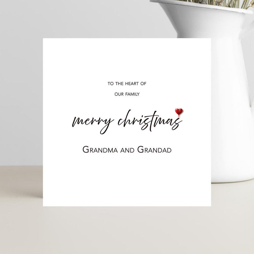 Minimalist Xmas card to the Heart of our Family card for grandparents with small red heart.