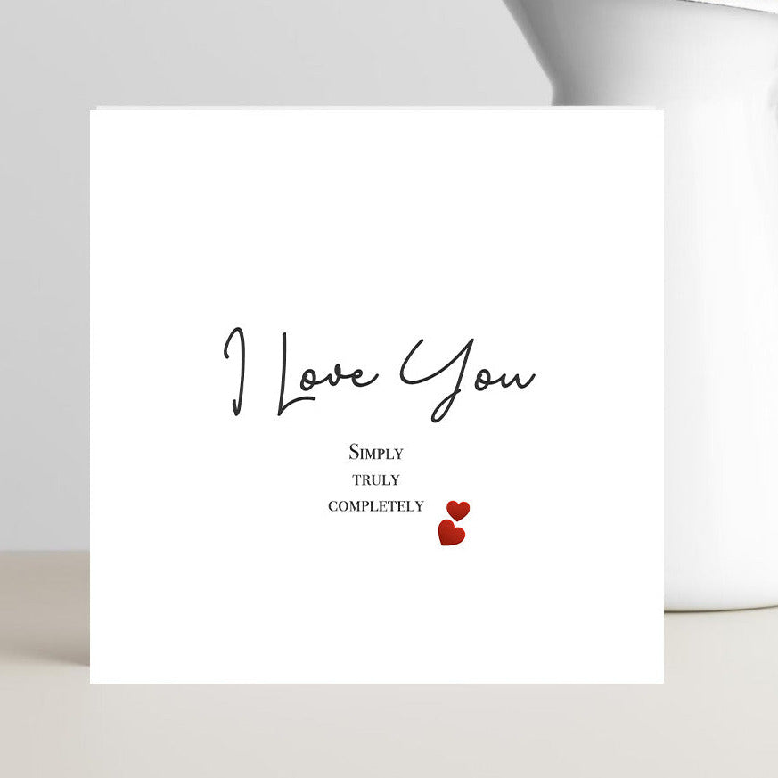 Valentine’s Day card with the caption “I love you, simply, truly, completely” displayed in elegant romantic typography.