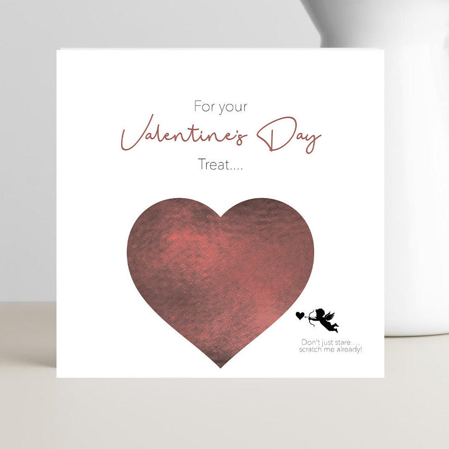 Valentine’s Day scratch-off card featuring a cupid pointing an arrow at a heart-shaped scratch-off area with the text “Don’t stare, scratch me already.”