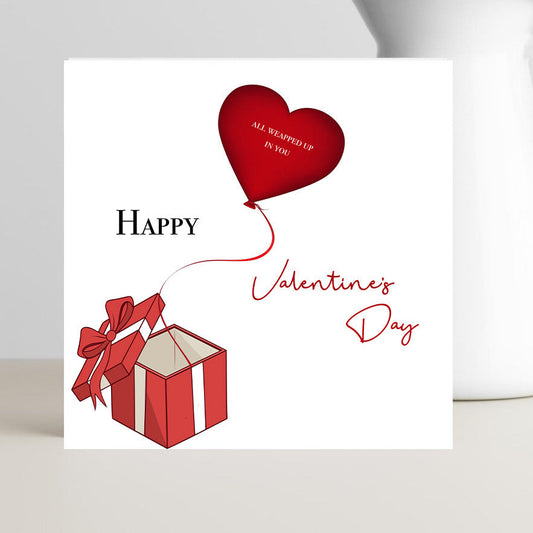 Valentine’s Day card with the caption “All wrapped up in you, Happy Valentine’s Day” shown in romantic, cozy typography.