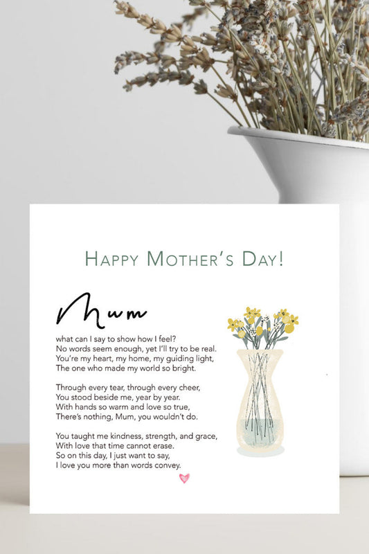 A Mother's Day greeting card with a poem titled 'mum' and a small illustration of yellow flowers in a vase, displayed on a light gray surface next to a white planter with dried flowers.