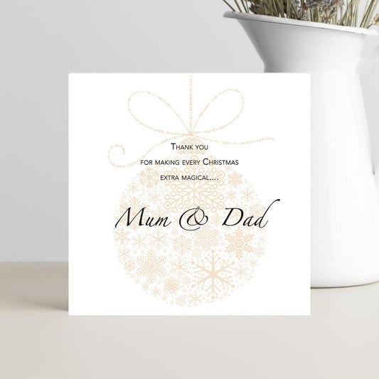 Greeting card with 'Thank you for making every Christmas extra magical... Mum + Dad' text on a white background.