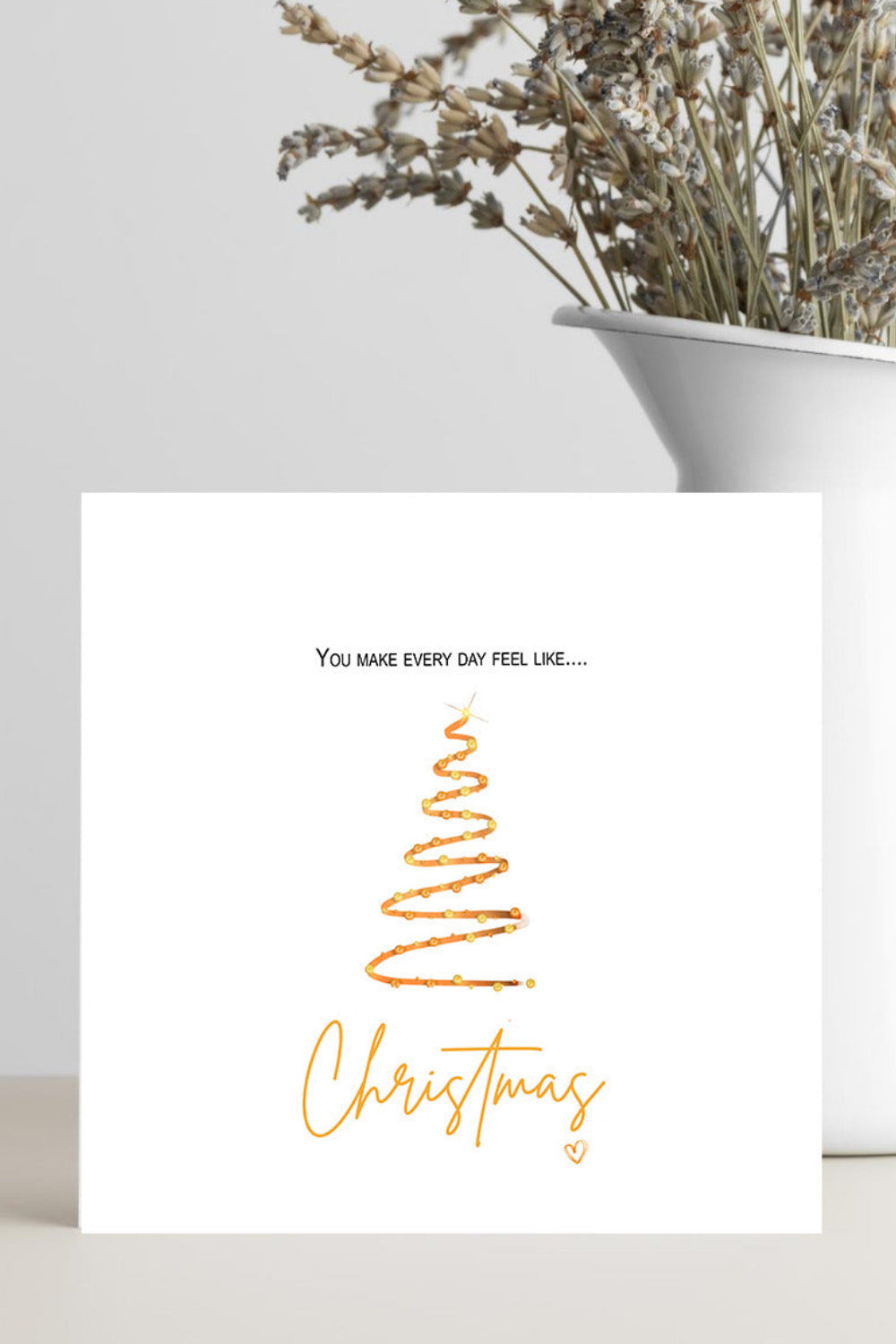 Card with 'You make every day feel like Christmas' text and a Christmas tree design.