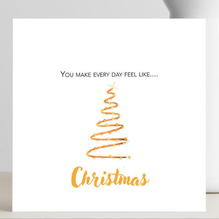 Card with 'You make every day feel like Christmas' text and a Christmas tree design.