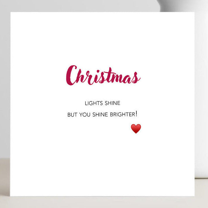 White card with red text and a heart with the wording you shine brighter.