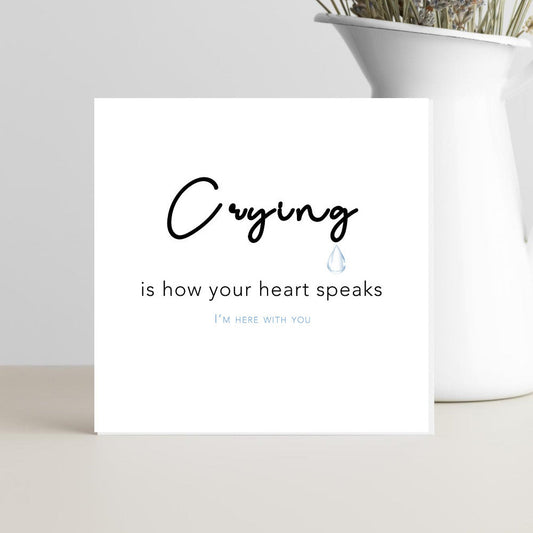 A minimalist condolence greeting card featuring the words “Crying is How Your Heart Speaks” in elegant script, placed on a soft neutral background conveying comfort, empathy, and warmth.