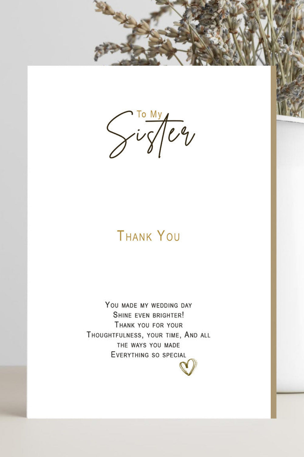 A white wedding thank-you card with elegant black and gold typography