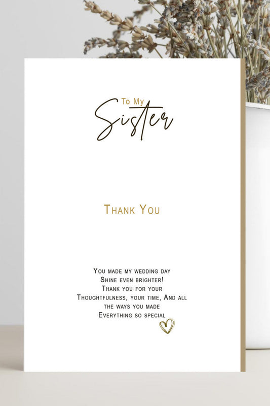 A white wedding thank-you card with elegant black and gold typography