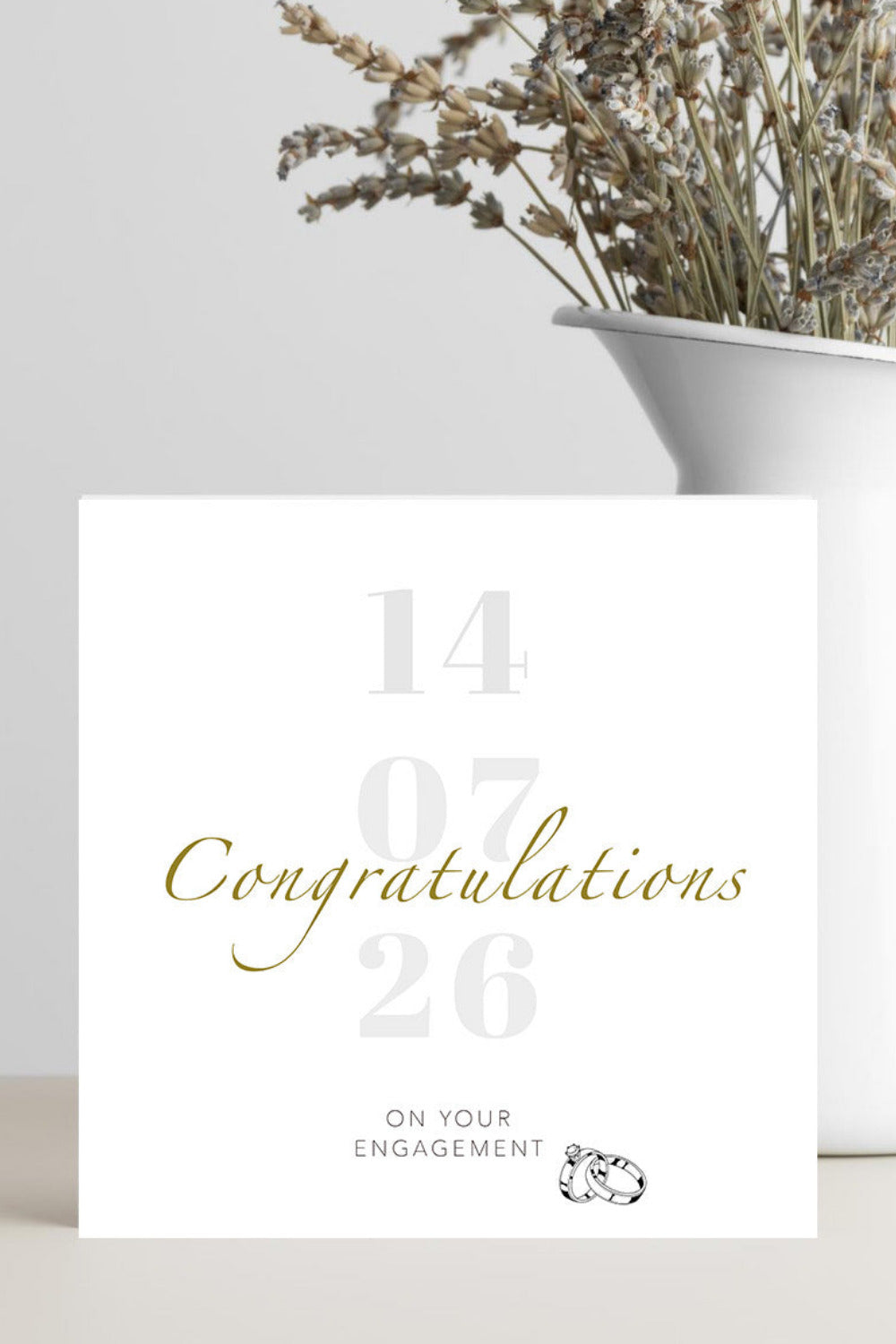 Engagement card with gold text on a white background
