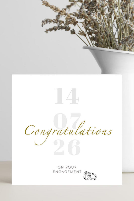 Engagement card with gold text on a white background
