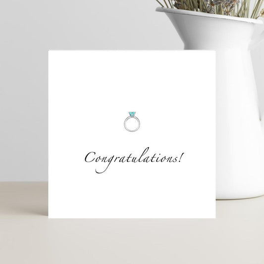 Minimalist engagement card with congratulations text and ring illustration