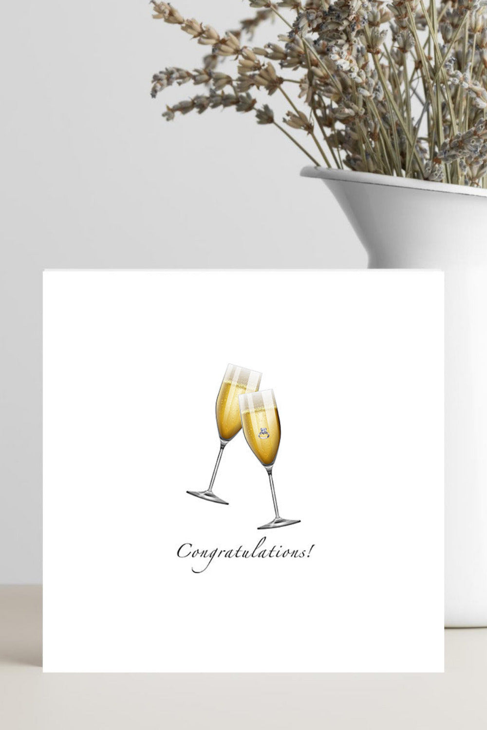 Greeting card with two champagne glasses and 'Congratulations!' text on a white background.