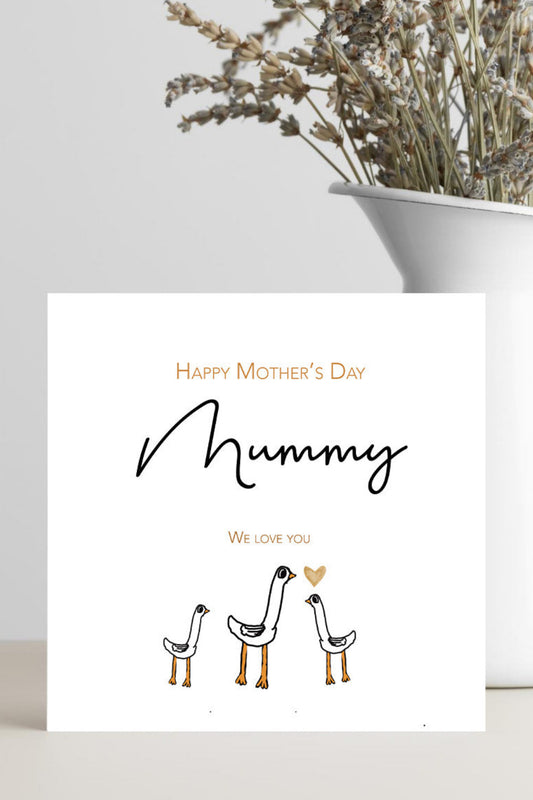 A white Mother's Day greeting card with the text 'Happy Mother's Day Mummy We love you' and three simple bird illustrations, styled in front of a white vase with dried flowers on a light surface.