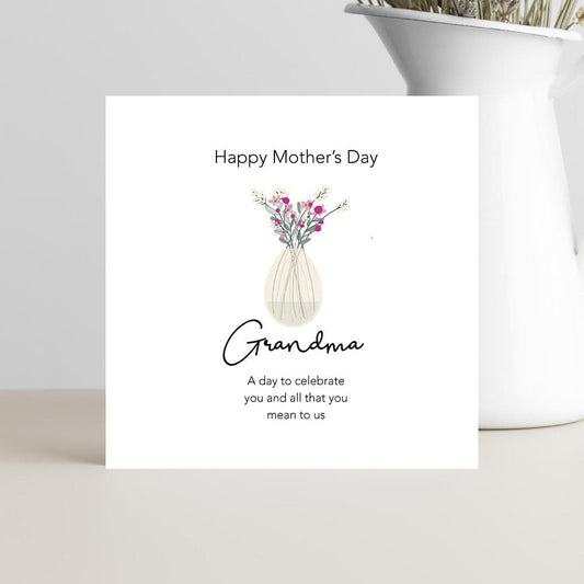 Mother's Day card for Grandma with a vase of flowers on a white surface.