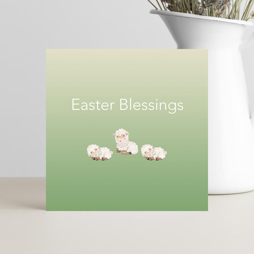 Easter Blessings greeting card with three cute baby lambs on the front