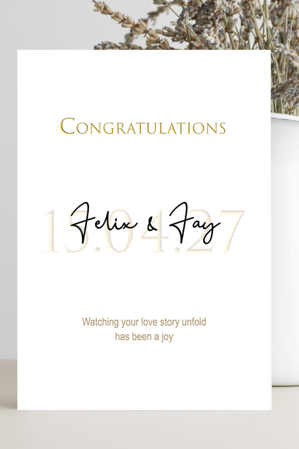 A white congratulations card with gold and black text