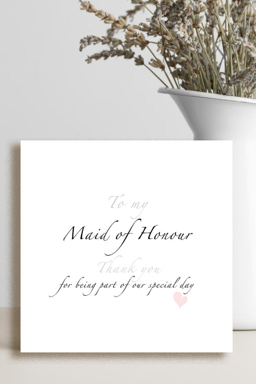 A square white card with elegant black and pale pink script text reading 'To my Maid of Honour thank you for being part of our special day,' 