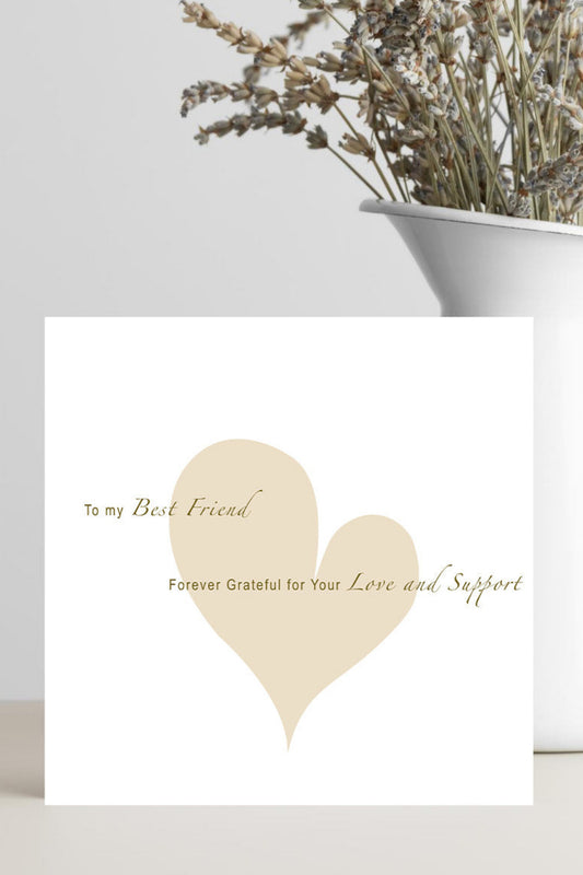A white greeting card with a large beige heart and cursive text reading 'To my Best Friend Forever Grateful for Your Love and Support,' styled in front of a white vase with dried flowers on a light surface.
