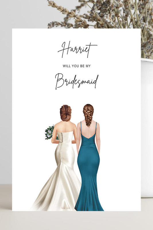 A wedding invitation card featuring an illustration of a bride in a white gown and a bridesmaid in a teal dress, with the text 'Harriet WILL YOU BE MY Bridesmaid'. The card is styled on a light beige surface next to a white vase with dried flowers.