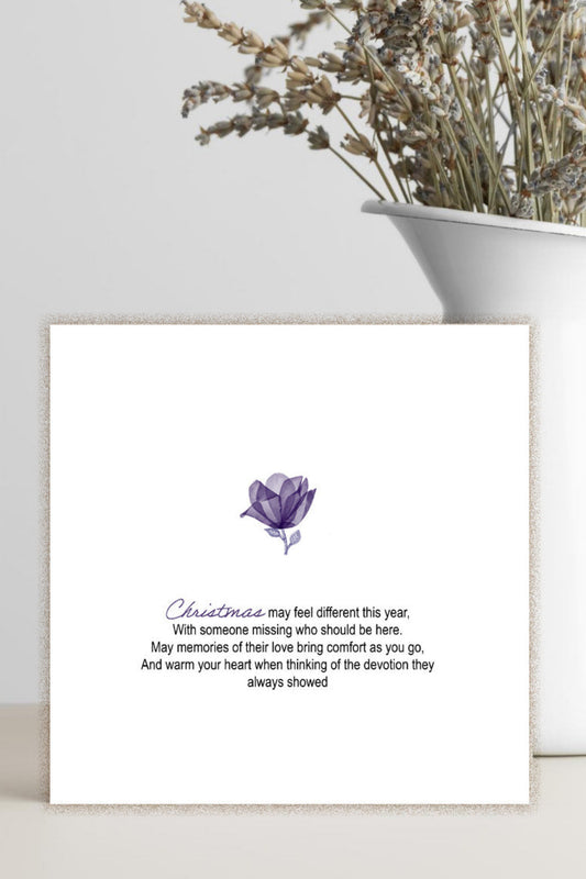 square white greeting card with a single purple flower and a verse of condolence.  Minimalist condolence card for Christmas.