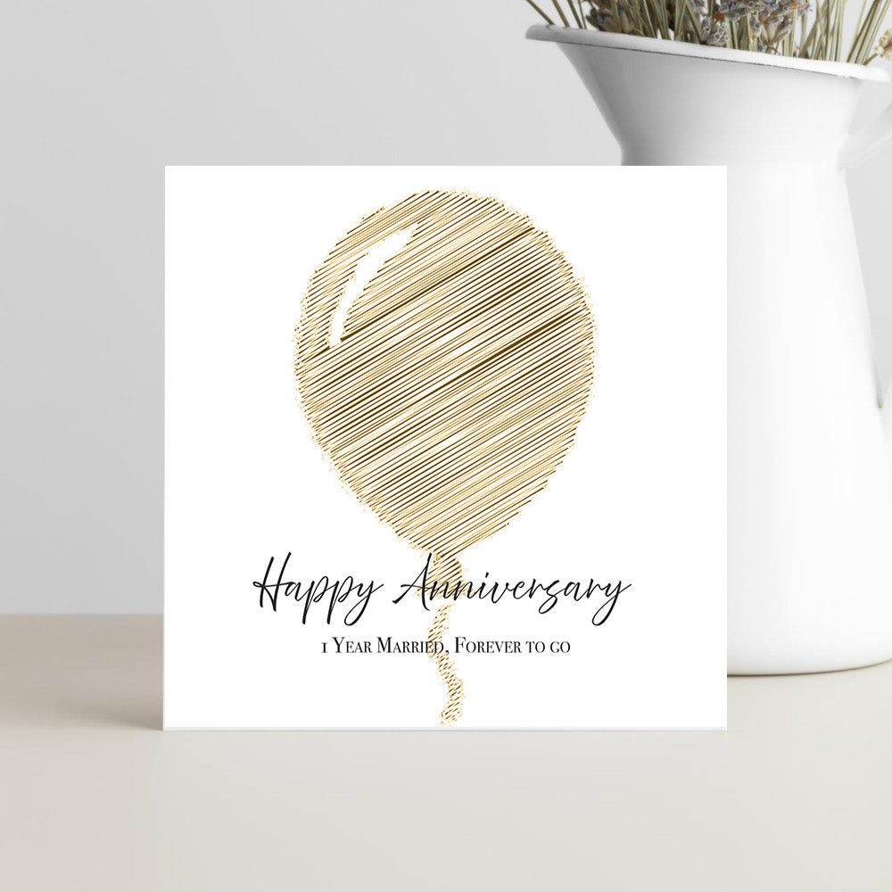 Greeting card with gold balloon design and 'Happy Anniversary' text on a white background.