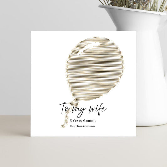 Greeting card with abstract design and text on a white surface.