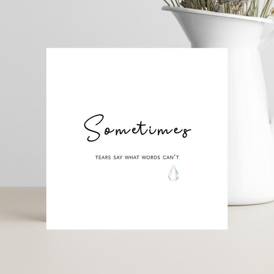 A soft, minimalist condolence greeting card displaying the message “Sometimes Tears Say What Words Can’t” in elegant script, placed on a neutral background with a calming, gentle tone.
