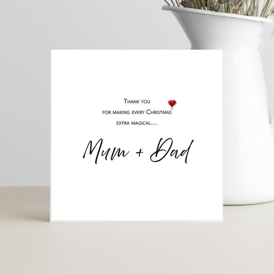 Greeting card with 'Thank you for making every Christmas extra magical... Mum + Dad' text on a white background.