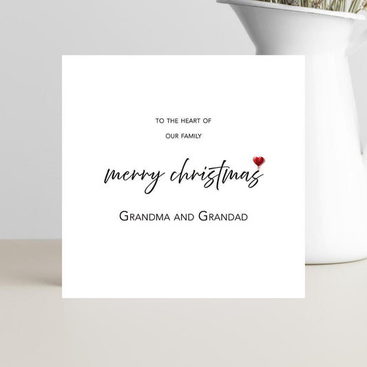Minimalist Xmas card to the Heart of our Family card for grandparents with small red heart.