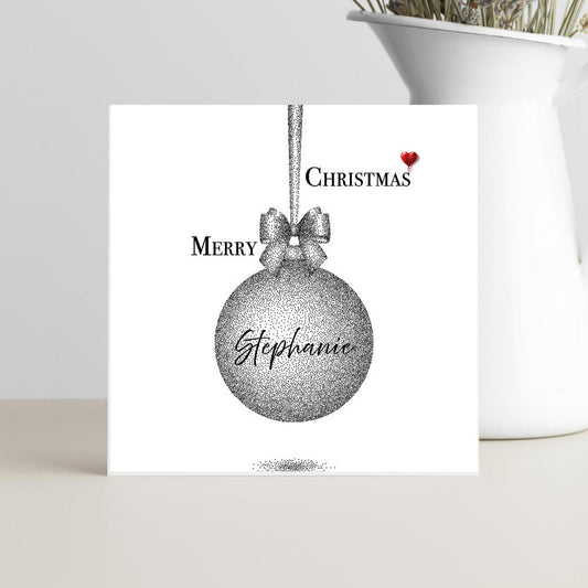 Christmas card with a red heart, silver ornament and personalised name.