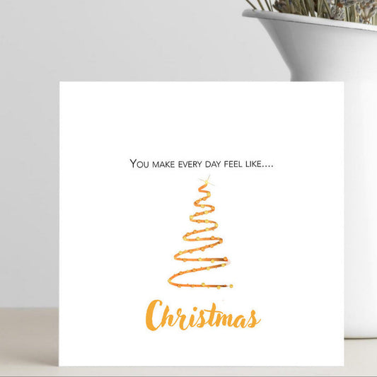 Card with 'You make every day feel like Christmas' text and a Christmas tree design.